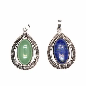 Detailed view of teardrop pendants featuring green and blue oval natural stone inlay