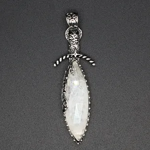 Detail view of a vintage sword pendant with faceted white crystal stone inlay.