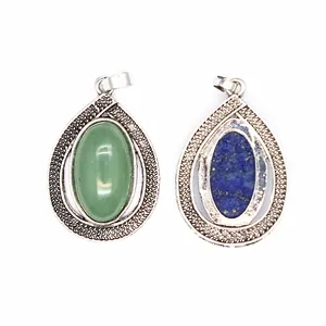 Detail shot of crystal teardrop pendants with vintage silver-tone textured borders.