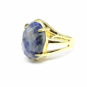 Detailed view of a gold-plated open ring featuring a large faceted blue natural stone.