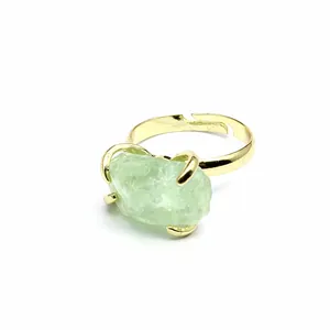 Close-up of a natural green fluorite raw stone ring with an adjustable gold band