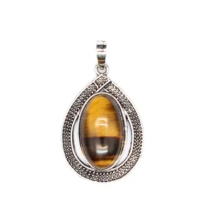 Elegant vintage teardrop tiger eye pendant with an intricate silver textured frame