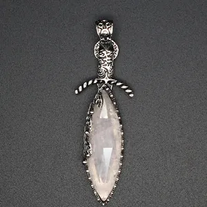 Close-up of a natural crystal stone sword pendant with intricate silver carvings.