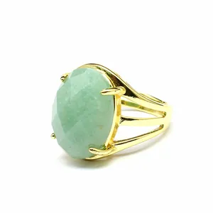 Close-up of vintage gold adjustable ring featuring a large faceted oval amazonite stone.