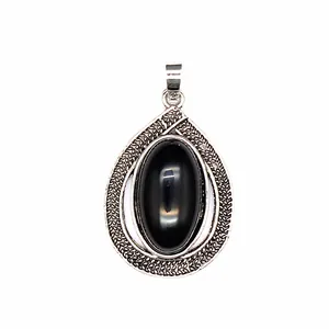 Detailed view of teardrop pendant with black oval stone and engraved silver frame.