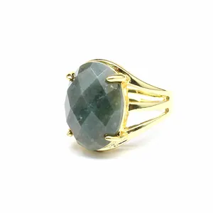 Close-up of vintage gold ring with large oval faceted green natural stone