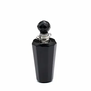 Detail view of a black natural stone perfume bottle pendant with faceted crystal cap