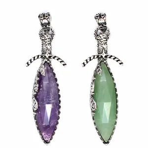 Detailed view of vintage-style sword pendants featuring purple and green natural crystals.