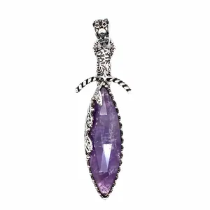 Close-up of a vintage silver sword pendant with a large purple marquise amethyst stone.