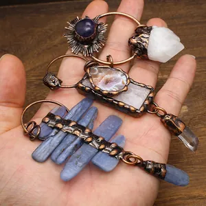 Macro shot of vintage pendants featuring raw natural crystals and copper settings.
