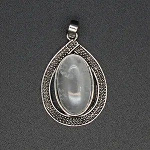Close-up detail of an elegant teardrop crystal pendant featuring a textured silver-tone frame