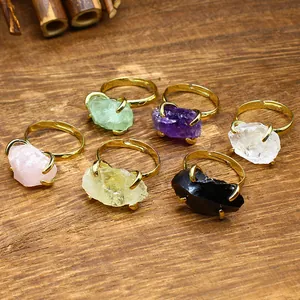 Set of six adjustable gold rings featuring assorted natural raw crystal stones.