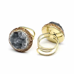 Macro detail of a gold adjustable ring featuring dark gray natural druzy agate stone.