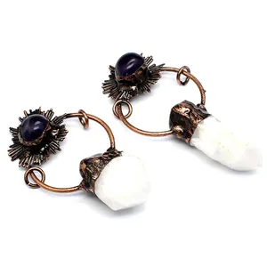 Close-up of vintage style white raw crystal and purple stone pendant set