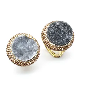 Detailed macro view of adjustable gold-toned ring featuring a natural grey druzy agate stone