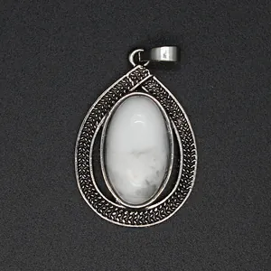 Detailed macro shot of an antique silver teardrop pendant with a white marbled oval stone