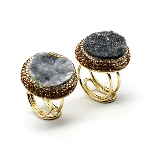 Detailed close-up of handmade adjustable druzy agate rings with sparkling crystal paving