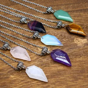 Macro view of assorted natural stone faceted necklaces on a rustic wooden surface