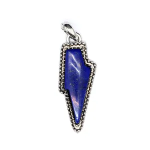 Detailed view of a retro lightning bolt pendant featuring a natural blue stone inlay.
