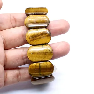 Detailed close-up showing the unique chatoyancy of a natural yellow tiger eye stone bracelet