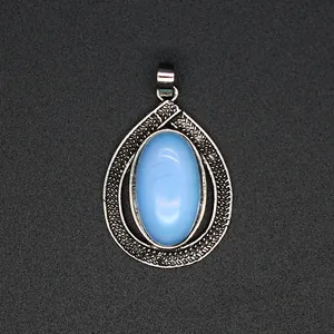 Detail showing the intricate silver texture and blue stone of the teardrop pendant.