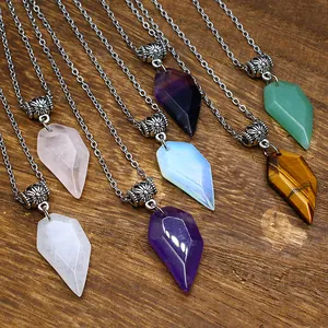 Macro detail of multi-colored faceted natural stone crystal pendant necklaces on wood surface