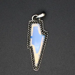 Detailed macro view showing the textured metal frame and white crystal of the lightning bolt pendant