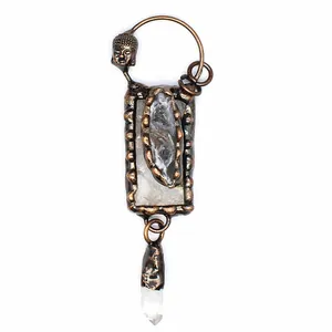 Close-up of a vintage bronze Buddha pendant with natural white crystal and druzy stone