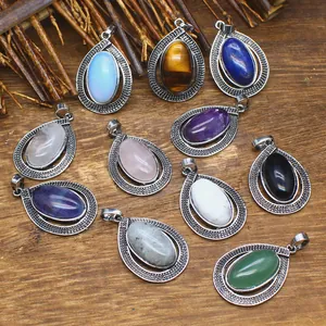 Variety of oval gemstone teardrop pendants with vintage silver filigree borders