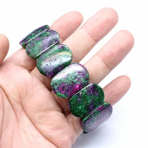 Detailed macro view of natural Ruby in Zoisite oval stone beads on a handmade bracelet.