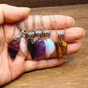 Detailed view of six various natural stone faceted heart pendants on silver chains