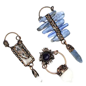 Detailed view of three vintage-style irregular raw crystal pendants with bronze settings