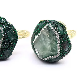 Detailed macro view of an ornate natural agate stone ring with green crystal inlay