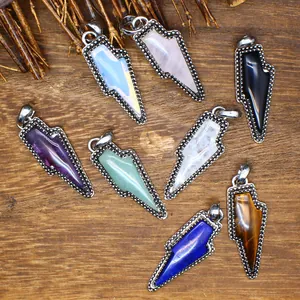 Macro detail view of natural stone lightning bolt pendants in various colorful crystals