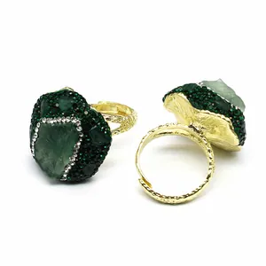 Detailed macro view of green natural agate druzy ring with an adjustable gold-tone band.