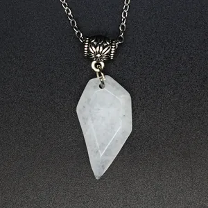 Macro detail of a faceted semi-transparent natural stone pendant on a silver-tone chain