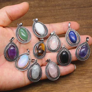 Macro view of teardrop pendants with colorful oval semi-precious stone insets