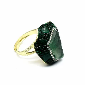 Detailed view of an adjustable handmade ring featuring a raw green druzy agate stone