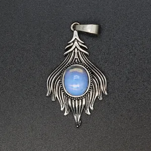 Macro view of vintage silver fox tail pendant featuring a central oval light blue stone