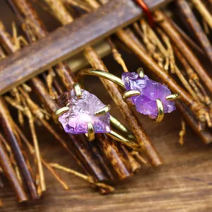 Close-up of a natural amethyst rough stone adjustable ring with gold-plated claw settings.