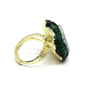 Side view of statement gold-plated ring featuring green natural stone and crystals