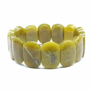 Close-up detail shot of polished oval yellowish-green natural stone beaded stretch bracelet