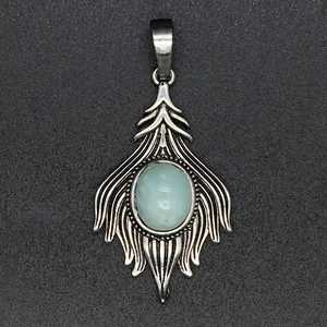 Detailed close-up of a vintage fox tail pendant with a light blue natural stone inlay