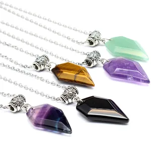 Detail view of faceted natural stone wolf tooth pendants in various crystal colors