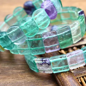 Detailed macro view showing the natural texture of green and purple square fluorite beads