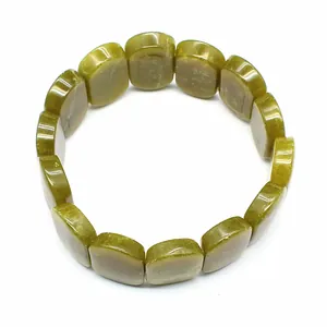 Close-up detail of natural olive green oval stone beads on an elastic bracelet