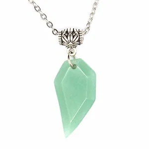 Close-up detail of a faceted light green natural stone wolf tooth pendant necklace