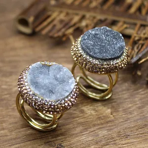 Close-up of handmade druzy agate rings with sparkling crystal inlay and gold finish