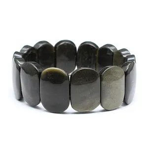 Detail view of 11x18mm polished oval golden obsidian stone bracelet beads