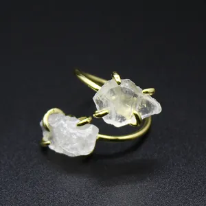 Macro view of double raw natural stones set in a gold-plated adjustable ring band.